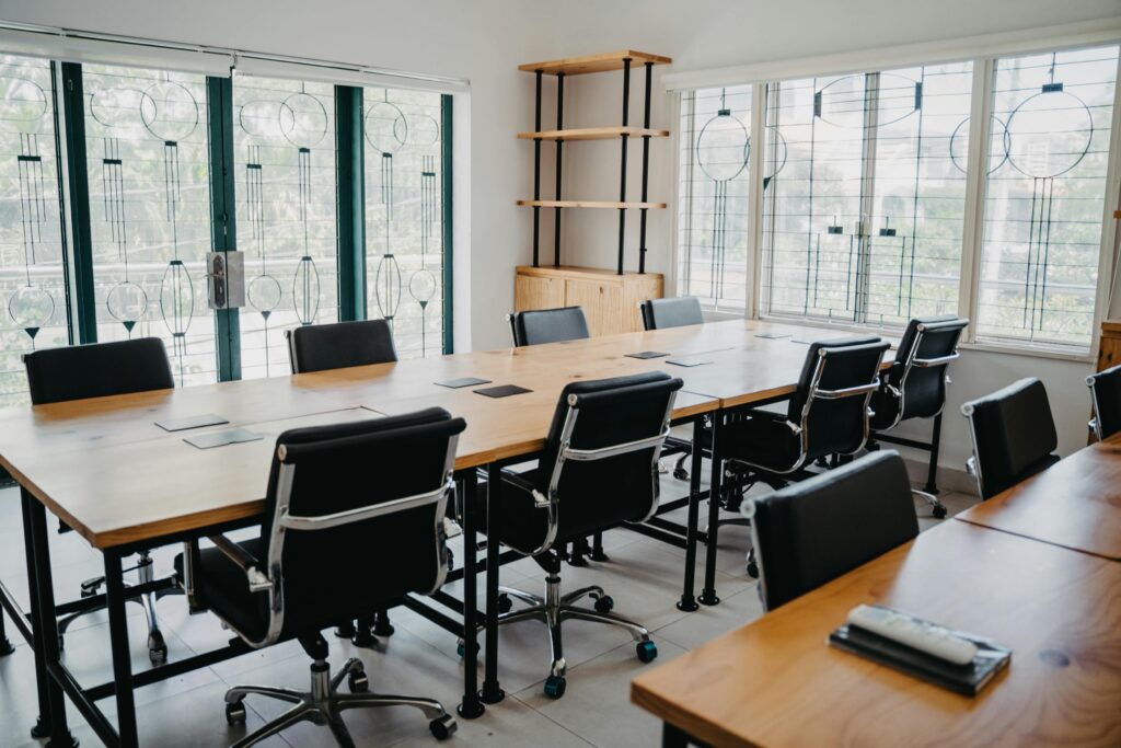 black office chairs lined up at a table. floor-to-ceiling windows in the back. The best commercial cleaning services in Lakewood