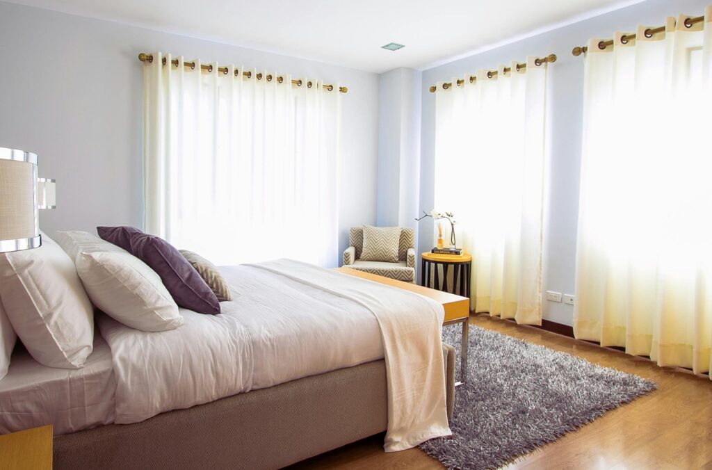 Bedroom with a rug over hardwood floors, professionally cleaned by Soul Cleaners