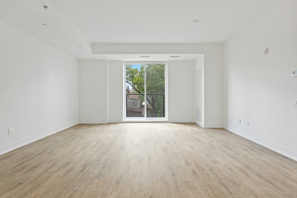 Empty room with honey-colored floors. The best move-out cleaning services in Wheat Ridge